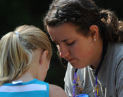 Counselor helping camper